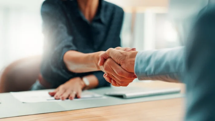 Handshake between a Conuity team member and a client
